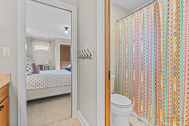 bathroom with tile patterned flooring, vanity, and toilet