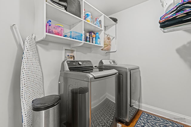 laundry room featuring separate washer and dryer and dark hardwood / wood-style floors