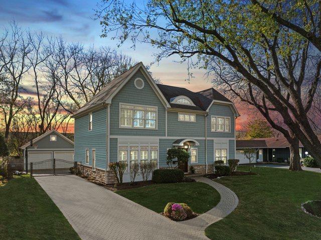 view of front of house featuring a garage, an outdoor structure, and a yard