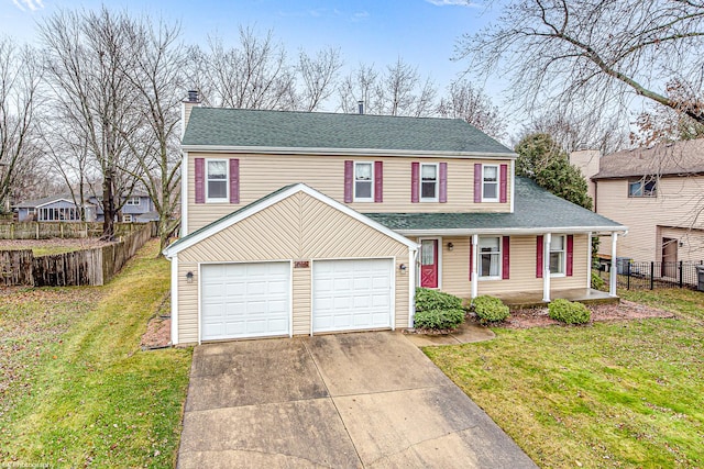 view of front of house featuring a garage, a front yard, and covered porch