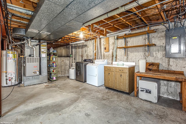 basement with heating unit, independent washer and dryer, electric panel, and water heater