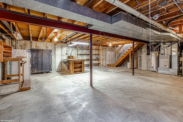 basement featuring heating unit and gas water heater