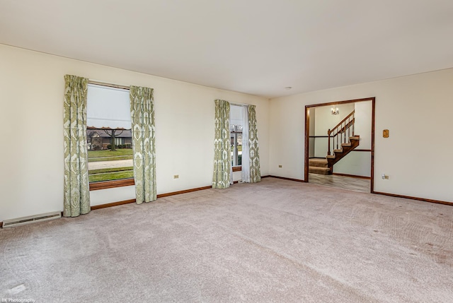 unfurnished room featuring light colored carpet