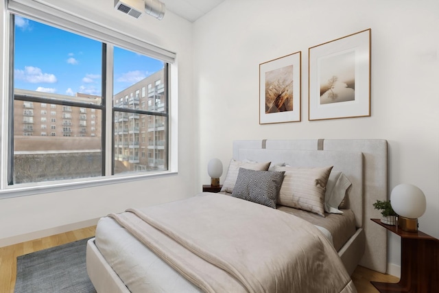 bedroom with hardwood / wood-style flooring