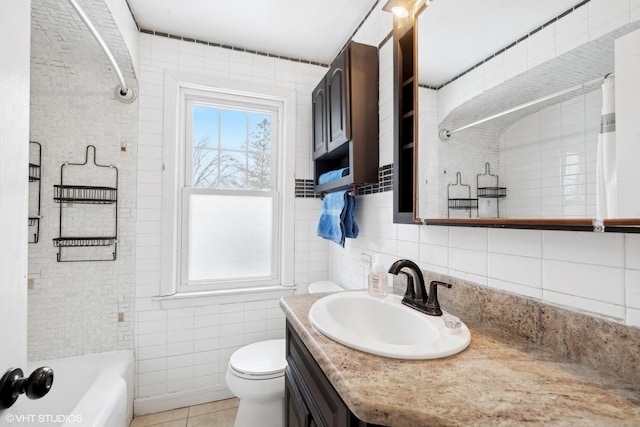 bathroom with tile patterned flooring, tile walls, toilet, and vanity