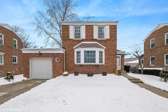 view of front of home with a garage, brick siding, and driveway