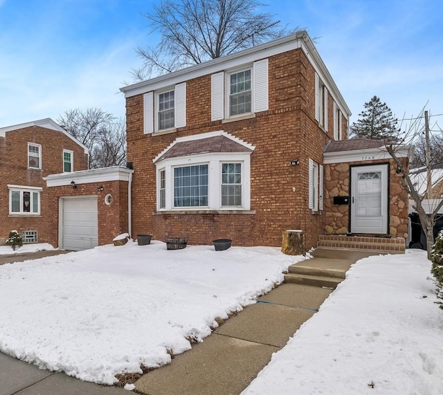 view of front of house featuring a garage and brick siding