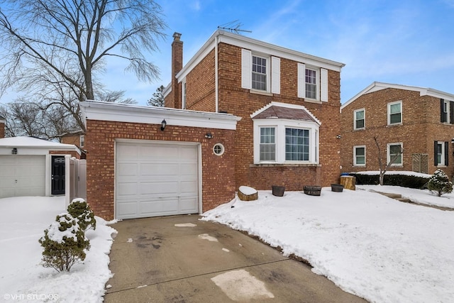 traditional home with a garage, concrete driveway, brick siding, and a chimney