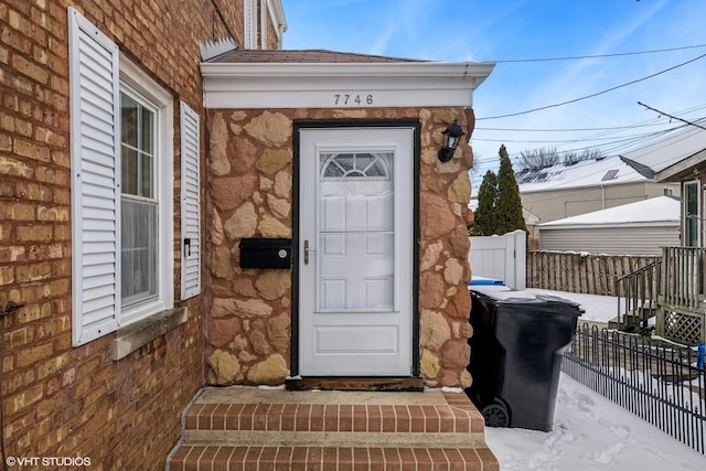 view of exterior entry with fence