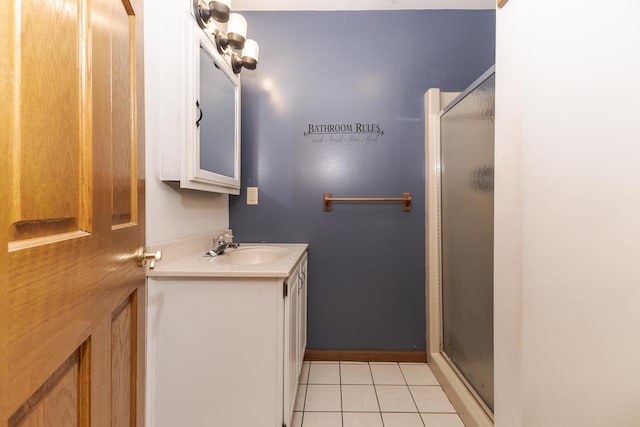 bathroom with tile patterned floors, vanity, and an enclosed shower