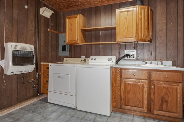 washroom featuring washing machine and dryer, electric panel, wood walls, cabinets, and heating unit