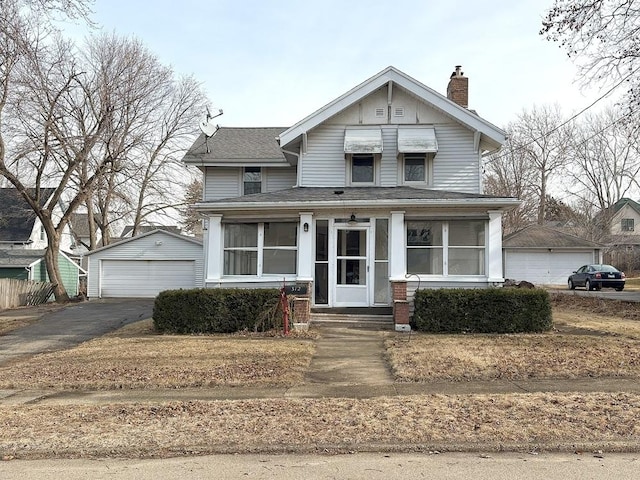 view of front of home featuring a garage and an outbuilding