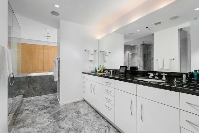 bathroom featuring vanity and shower with separate bathtub