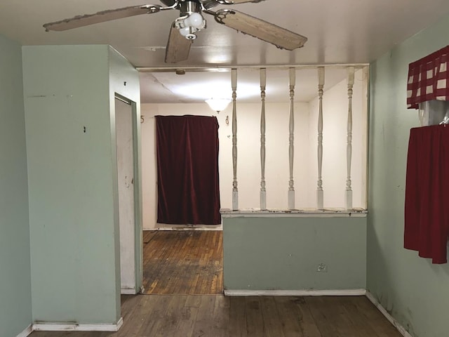 unfurnished room featuring ceiling fan and dark hardwood / wood-style flooring