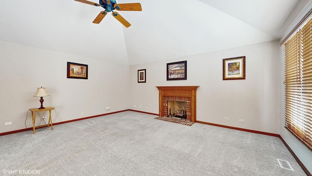 unfurnished living room with vaulted ceiling, a brick fireplace, visible vents, and carpet