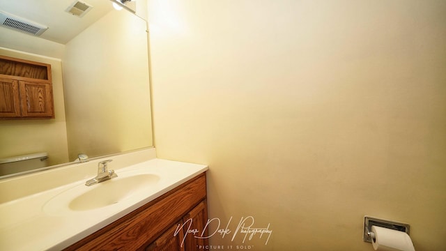 bathroom featuring vanity and toilet