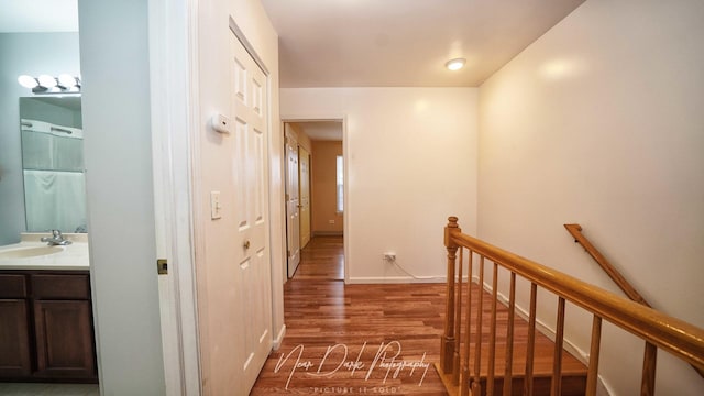 hall featuring dark hardwood / wood-style flooring and sink