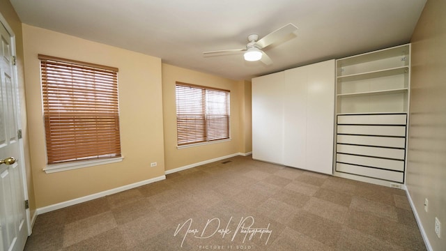 unfurnished bedroom with light colored carpet and ceiling fan