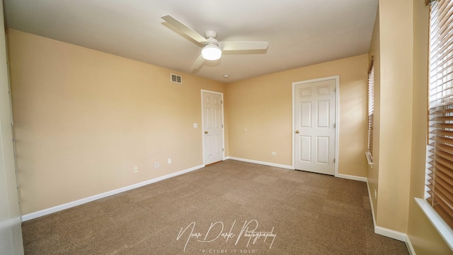 unfurnished bedroom featuring ceiling fan and carpet