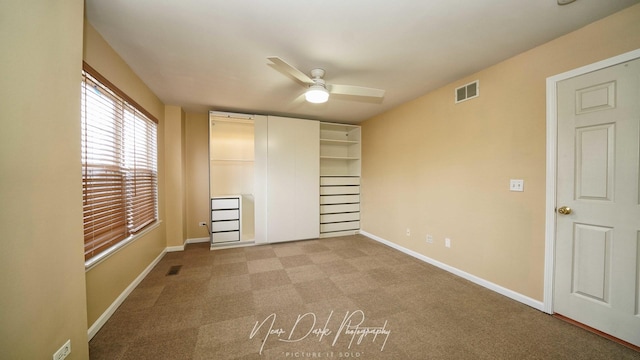 unfurnished bedroom with ceiling fan and light colored carpet