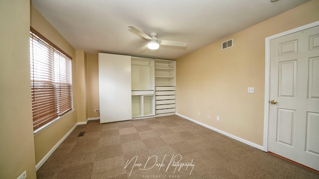 unfurnished bedroom featuring ceiling fan, a closet, and light carpet