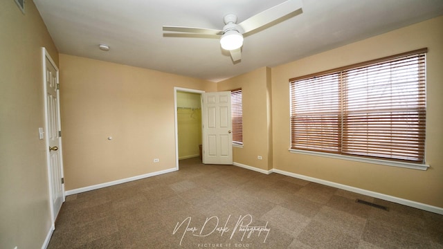 unfurnished bedroom with carpet, ceiling fan, and a closet