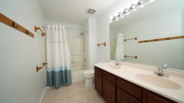 full bathroom with vanity, toilet, tile patterned flooring, and shower / bath combo with shower curtain