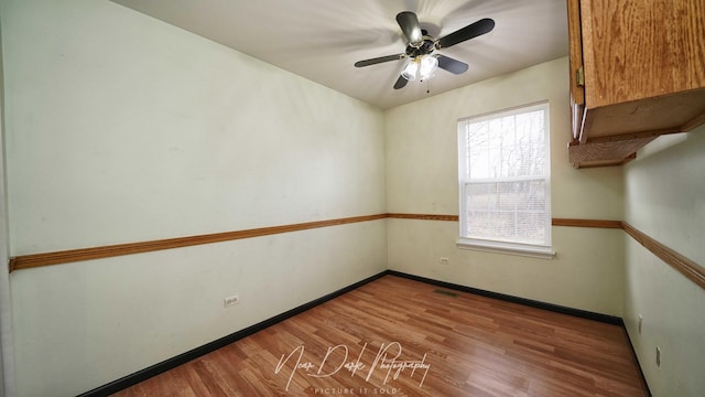 unfurnished room with hardwood / wood-style floors and ceiling fan