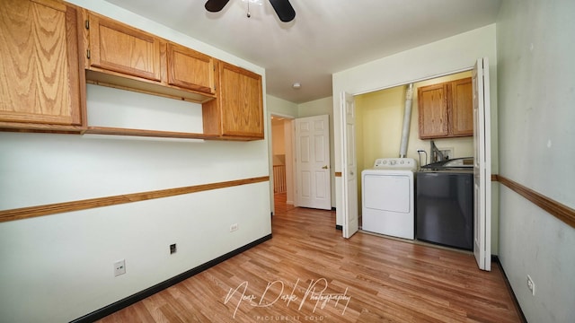 clothes washing area featuring cabinets, ceiling fan, washer and dryer, and light hardwood / wood-style floors