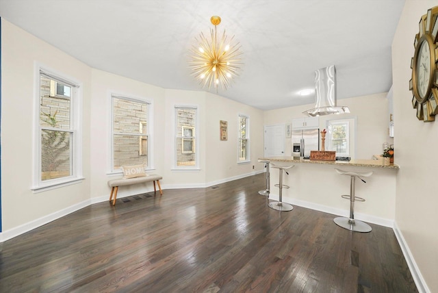 living room with dark hardwood / wood-style floors and a notable chandelier