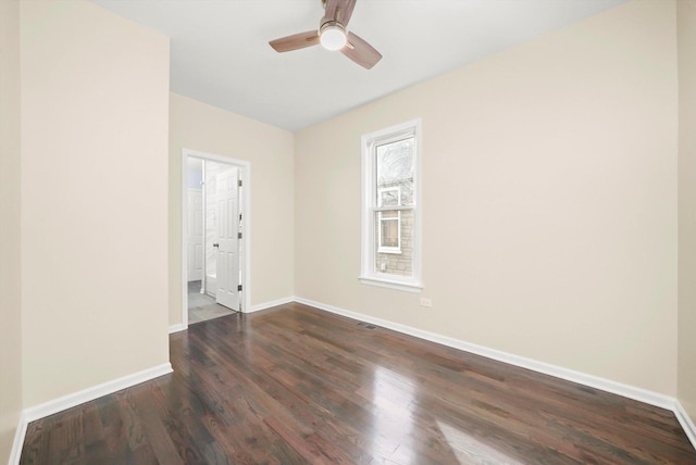 spare room with ceiling fan and dark hardwood / wood-style flooring