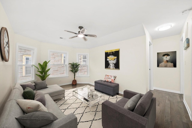 living room featuring hardwood / wood-style floors and ceiling fan