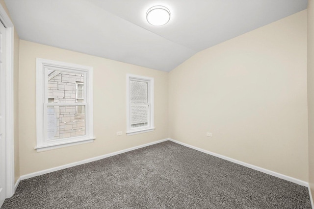 empty room with lofted ceiling and carpet floors