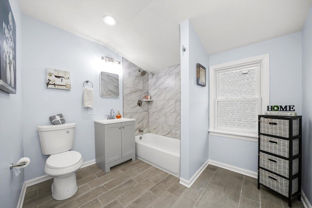 full bathroom featuring vanity, toilet, tiled shower / bath combo, and vaulted ceiling