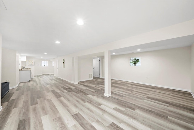 basement featuring light hardwood / wood-style flooring