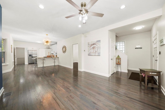 living room featuring dark hardwood / wood-style floors and ceiling fan