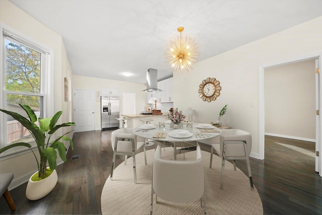 dining area featuring a notable chandelier and dark hardwood / wood-style flooring