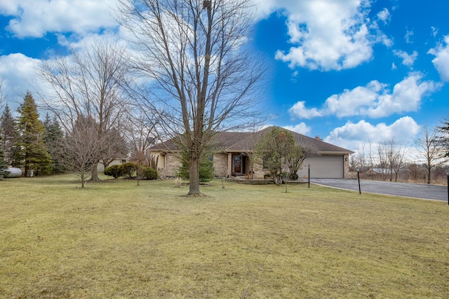 ranch-style home with a garage and a front yard