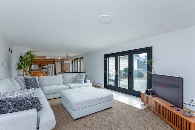 carpeted living room with baseboard heating and french doors