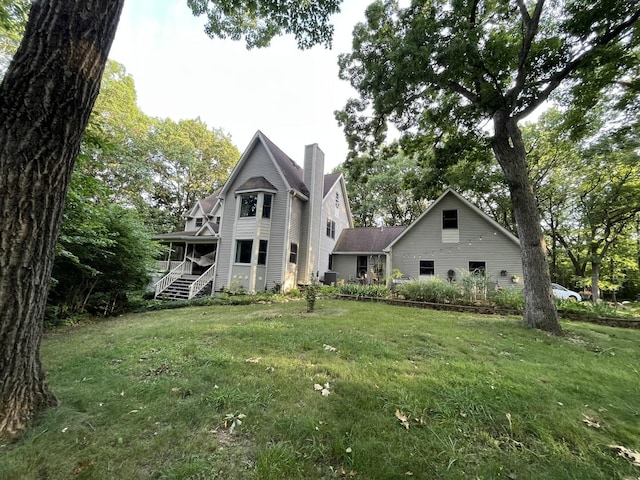 rear view of house with a yard