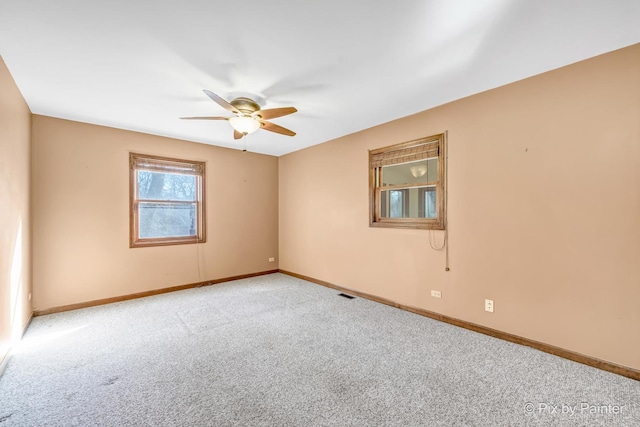 unfurnished room featuring light colored carpet and ceiling fan