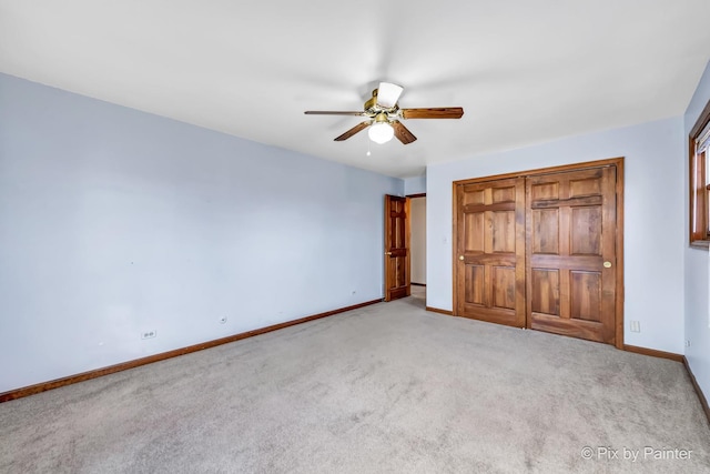 unfurnished bedroom with light carpet, a closet, and ceiling fan