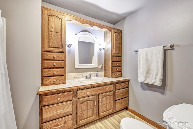 bathroom featuring vanity and toilet