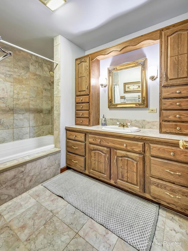 bathroom featuring vanity and tiled shower / bath combo