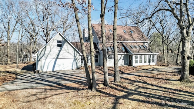 view of front facade featuring a garage and a sunroom