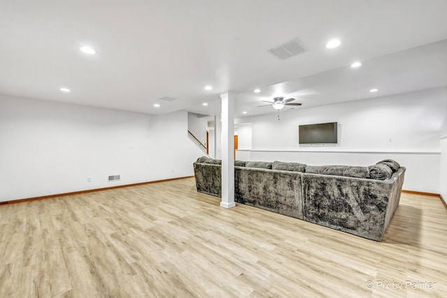 living room featuring ceiling fan and light hardwood / wood-style floors