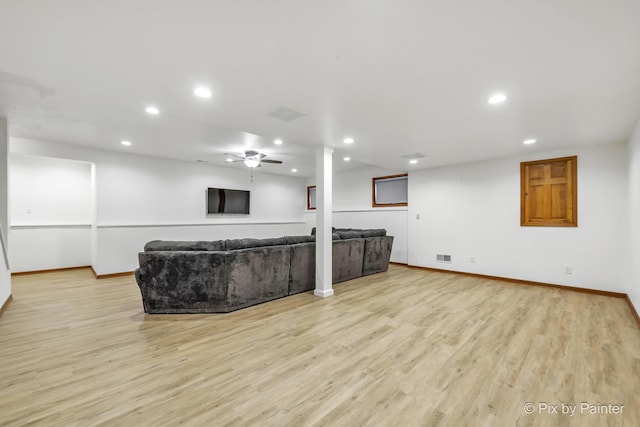 living room featuring ceiling fan and light hardwood / wood-style floors