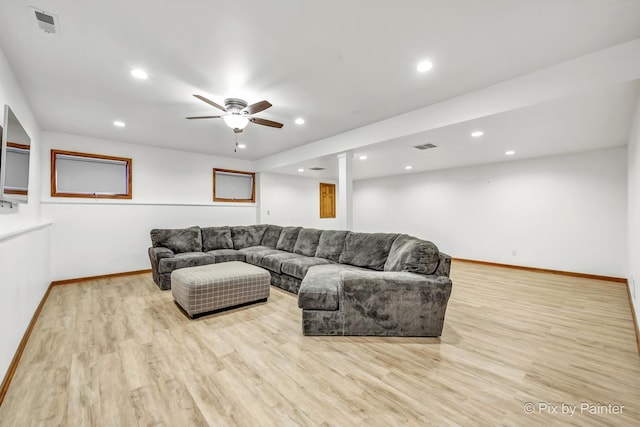 living room with ceiling fan and light wood-type flooring