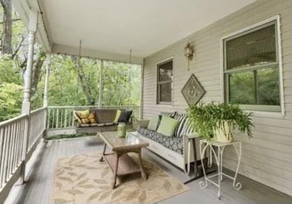 wooden terrace with an outdoor living space