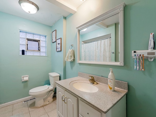 bathroom featuring tile patterned floors, vanity, and toilet